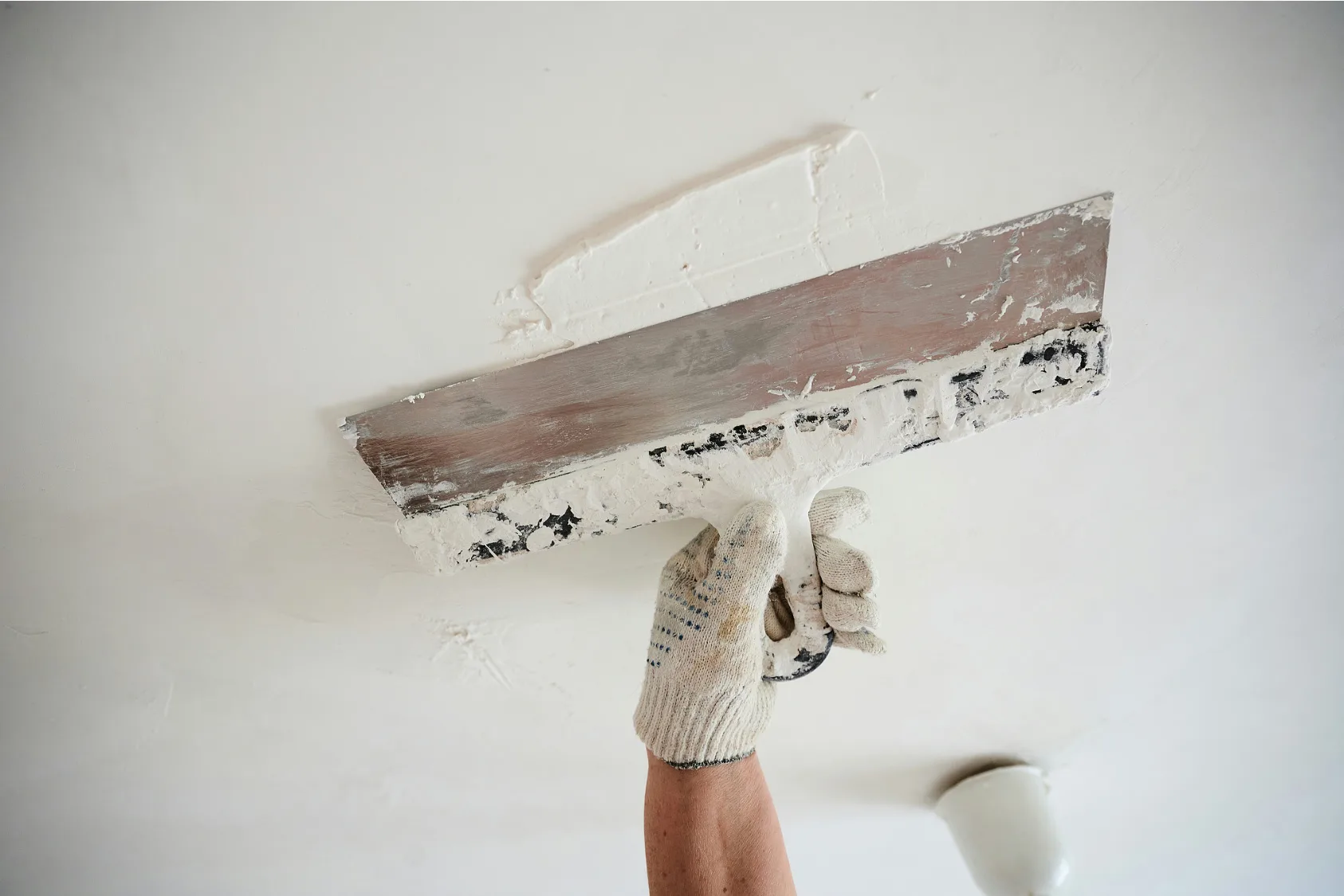Applying-Plaster-with-Scrapper-for-Smoothing