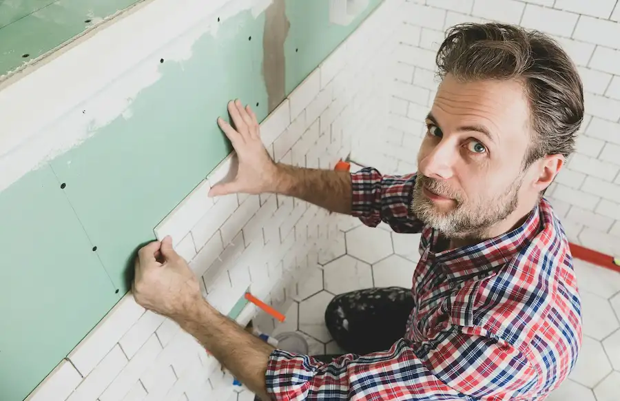 worker-installing-tiles-in-bathroom